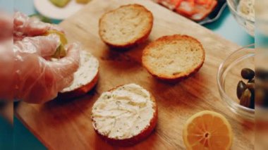Preparing process of Cinematographic Smoked Salmon bagels. USA cusine.