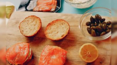 Preparing process of Cinematographic Smoked Salmon bagels. USA cusine.
