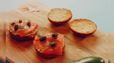 Preparing process of Cinematographic Smoked Salmon bagels. USA cusine.