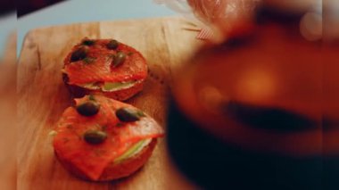 Preparing process of Cinematographic Smoked Salmon bagels. USA cusine.