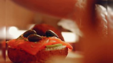 Preparing process of Cinematographic Smoked Salmon bagels. USA cusine.