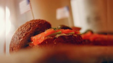 Preparing process of Cinematographic Smoked Salmon bagels. USA cusine.