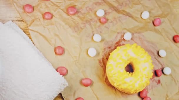 Pink Donuts Decorated Yellow Icing Donuts Piece Paper Decorated Candy — Stock Video