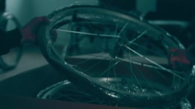 A disabled man assembles a stroller. Assembling strollers for people with disabilities in a poor country.