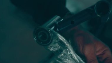 A disabled man assembles a stroller. Assembling strollers for people with disabilities in a poor country.