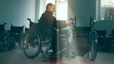 A disabled man assembles a stroller. Assembling strollers for people with disabilities in a poor country.