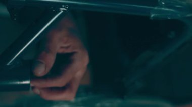 A disabled man assembles a stroller. Assembling strollers for people with disabilities in a poor country.