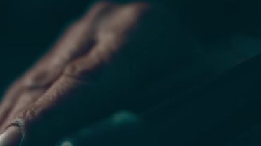 A disabled man assembles a stroller. Assembling strollers for people with disabilities in a poor country.