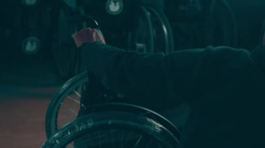 A disabled man assembles a stroller. Assembling strollers for people with disabilities in a poor country.