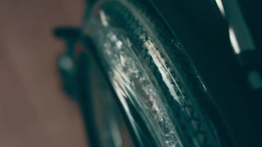 A disabled man assembles a stroller. Assembling strollers for people with disabilities in a poor country.