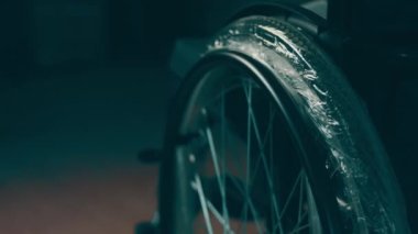 A disabled man assembles a stroller. Assembling strollers for people with disabilities in a poor country.
