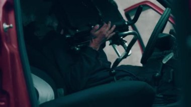 The disabled person enters the car and loads the stroller. Car for the disabled.