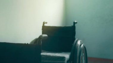 A disabled man assembles a stroller. Assembling strollers for people with disabilities in a poor country.