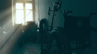 A disabled man assembles a stroller. Assembling strollers for people with disabilities in a poor country.