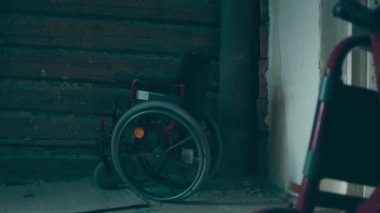 A disabled man assembles a stroller. Assembling strollers for people with disabilities in a poor country.