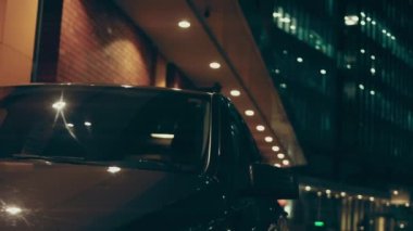 Silhouette of beautiful car on smoked dark background . Car lights on fog