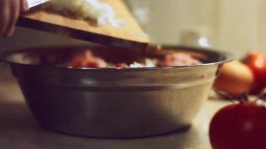 Ravioli dolgusu için malzemelerin yakın plan çekimi. Metalik bir kasede kıyma, soğan, yumurta, tuz ve karabiber karışımı. Evde ravioli hazırlama süreci. 4 K video.