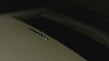 Lüks bir arabanın içinde. Bir adam bardak tutucuyu eliyle açar. 4K video.