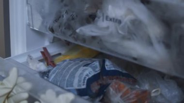 Meat stock, meat reserve during the COVID-19 pandemic. Chicken meat storage and organization in a freezer. Woman puts in the fridge cut chicken. Timelapse. 4K video.