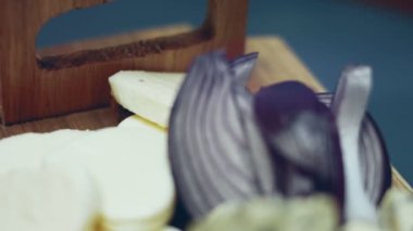 Kadın eli, ton balıklı pizza için diğer malzemelerin yanına dilimlenmiş kırmızı soğan koyuyor. 4K video. Sanatçı çekimi, yavaş çekim.