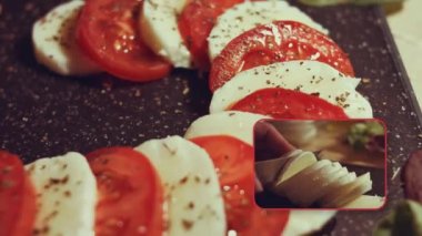 Caprese - İtalyan ulusal yemeği. Noel şeker kamışı şeklinde dilimlenmiş domates ve mozarella. Fesleğen ve zeytinyağıyla servis edilir. Yavaş çekim.