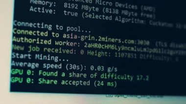 Cryptocurrency mining on a computer screen. The algorithm of the computer program on the monitor. Execution of the program code for the mining program. Pop-up lines of a computer program.