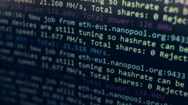 Cryptocurrency mining on a computer screen. The algorithm of the computer program on the monitor. Execution of the program code for the mining program. Pop-up lines of a computer program.