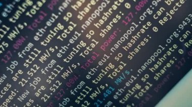 Cryptocurrency mining on a computer screen. The algorithm of the computer program on the monitor. Execution of the program code for the mining program. Pop-up lines of a computer program.