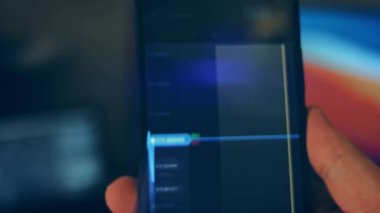 Caucasian male making a payment with bitcoins cryptocurrency using his smartphone. Custom application interface design. 4K UHD RAW edited footage