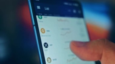 Caucasian male making a payment with bitcoins cryptocurrency using his smartphone. Custom application interface design. 4K UHD RAW edited footage