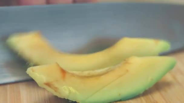 Chef Black Gloves Peels Cuts Avocado Wooden Table — Stock Video