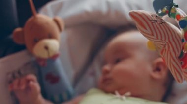 newborn baby human child lies on his back in a stroller at home