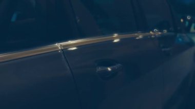 Silhouette of beautiful car on smoked dark background . Car lights on fog