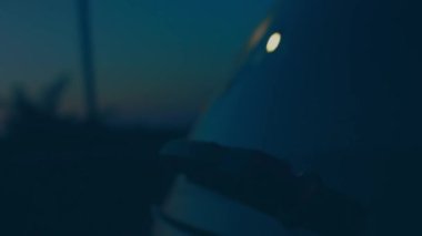 Silhouette of beautiful car on smoked dark background . Car lights on fog