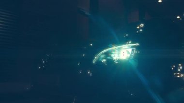 Silhouette of beautiful car on smoked dark background . Car lights on fog