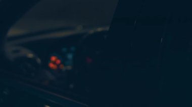 Silhouette of beautiful car on smoked dark background . Car lights on fog