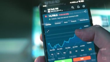 Cep telefonu ekranında borsa grafiği. Mal varlığı yatırımı. US Tech 100 'ün fiyatı, borsa döviz kuru. Hologram etkisi. Makro görünüm.