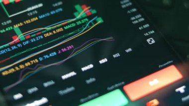 Akıllı telefon kullanan yatırımcı finansal veri kripto borsasını, bozuk para fiyatını analiz ediyor. Endeksler zaman borsası duvarında aşağı yukarı değişiyor. Çevrimiçi ticaret. Kripto para birimi konsepti. Makro