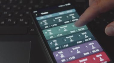 Cep telefonundaki internet hızını kontrol ediyorum, hız uygulamasını kullanarak. Ping, yükleme ve indirme hızı kontrol ediliyor. Makro görünüm.