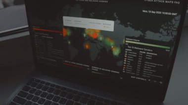 Bilgisayar ekranında dünya haritası olan küresel siber saldırı. İnternet ağı iletişimi siber saldırı altında. Dünya çapında virüs yayılımı çevrimiçi. - Yakın çekim. El bilgisayarı atışı