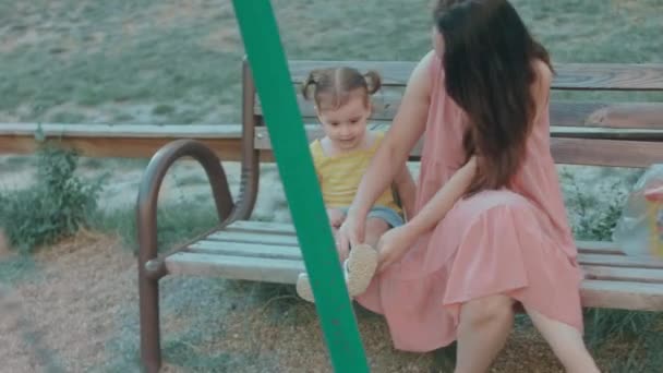 Mom Daughter Sitting Bench Playground Caucasian Young Happy Woman Cleaning — Stock Video