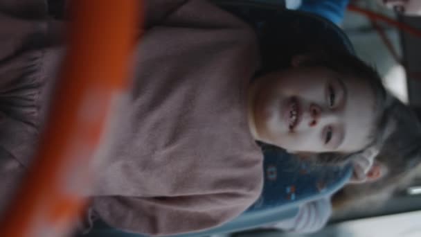 Vertical Shooting Cute Little Girl Smiling Enjoying Ride Bus — Stock Video