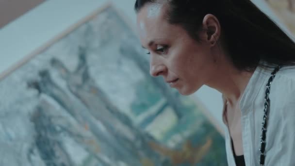 Kobieta Patrzy Kamerę Uśmiecha Się Galerii Sztuki Obrazami Ścianie Jako — Wideo stockowe