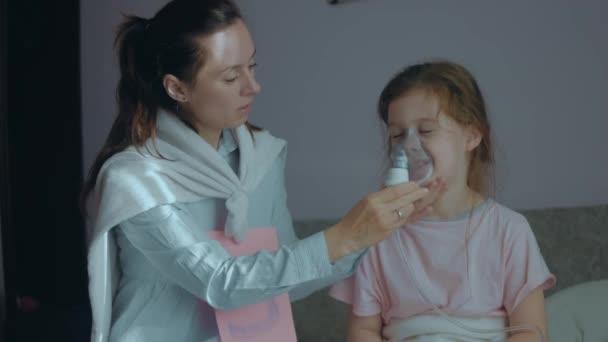 有爱心的母亲拿着呼吸面罩面对小女孩治疗疾病 吸入用呼吸面罩的医疗设备 超级妈妈的概念 — 图库视频影像