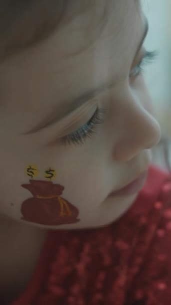 Serious Little Girl Sack Golden Coins Painting Her Face Banking — Stock Video