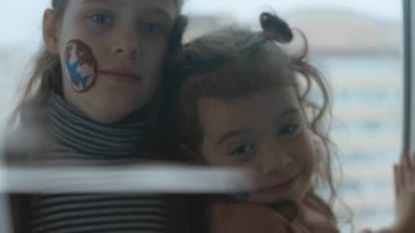 Yüzlerinde kargo ve nakliye resimleri olan iki neşeli küçük kız. Kargo ve nakliye konsepti