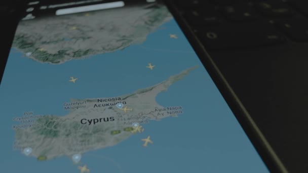 スマートフォン画面のグローバルマップ上のオンラインフライト追跡 ニコシア キプロス 船積み 物流コンセプト — ストック動画