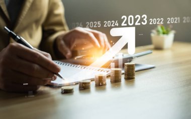 Interest rate and dividend concept, businessman calculating income and return on investment in 2023. income, return, retirement, compensation fund, investment,dividend tax,stock market, trend,strategy