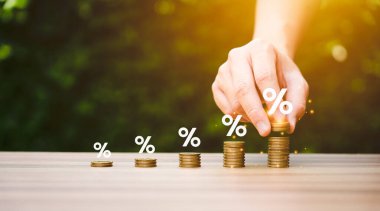 higher interest rates and dividends, pile of coins and percentage of company profits. saving money for Invest in growth and pay out dividends, cash reserves.compensation fund for retirement