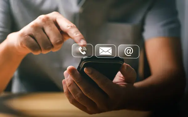 Stock image Man Using Smartphone to Access Communication Icons for Call, Email, and Internet, Representing Modern Digital Connectivity and Technology in Everyday Life